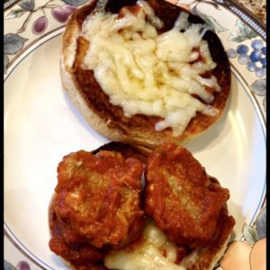 Smoky Meatballs with Sauce and Cheese on a Potato Roll
